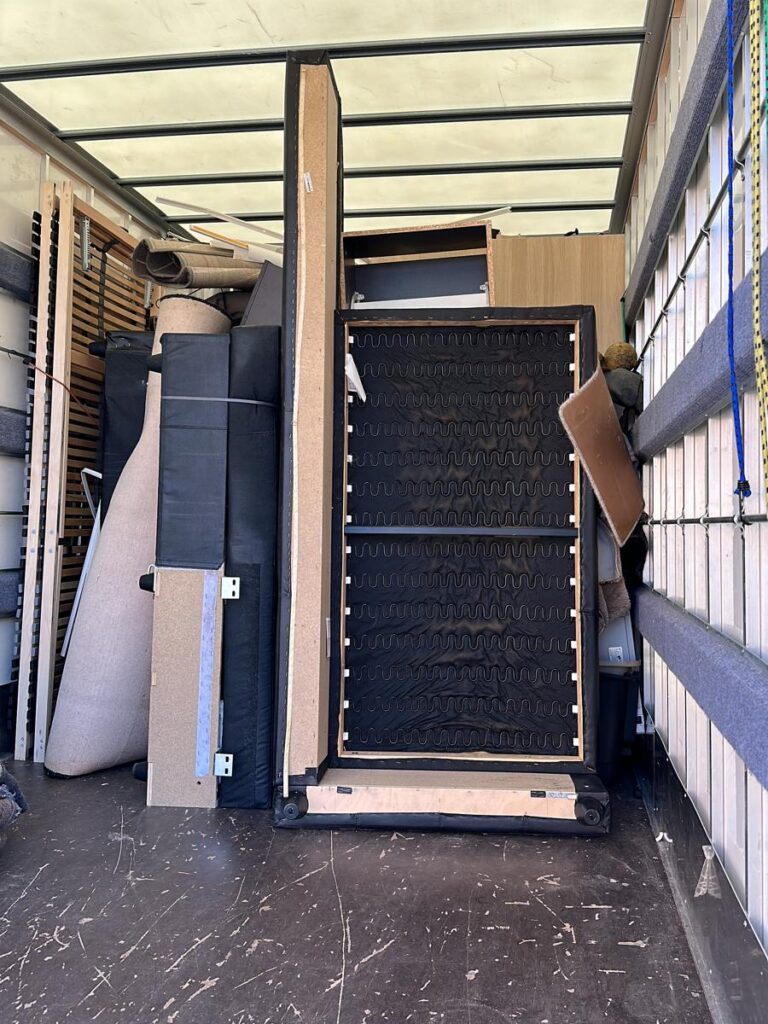 a truck with a box and mattresses